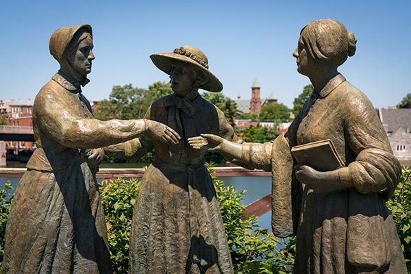 Susan B. Anthony, Elizabeth Cady Stanton, and Amelia Bloomer statue in Seneca Falls, NY along the river.